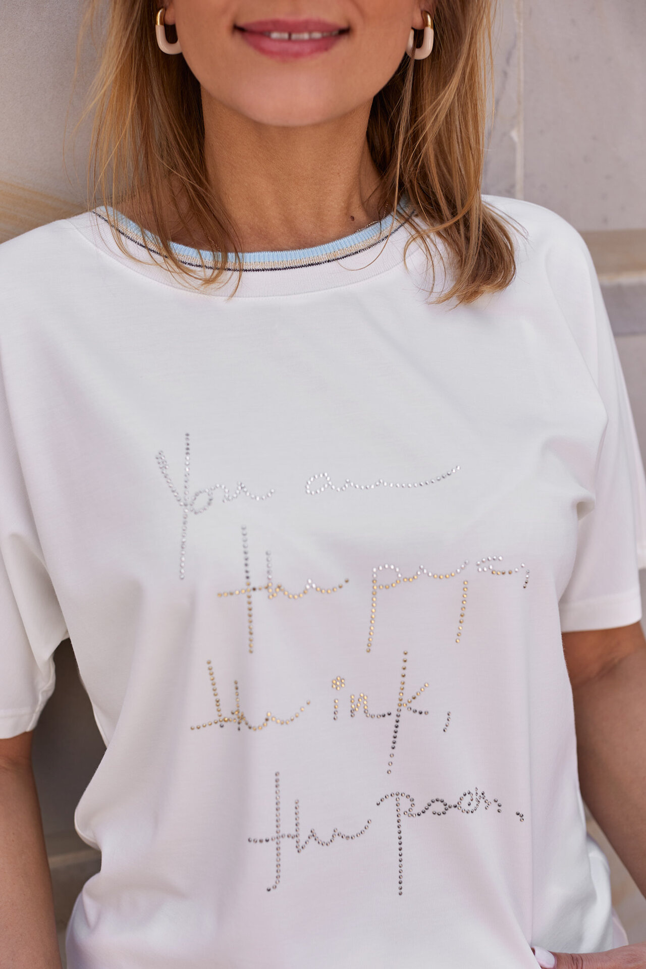 Sportily elegant blouse with rhinestones and a decorative cuff