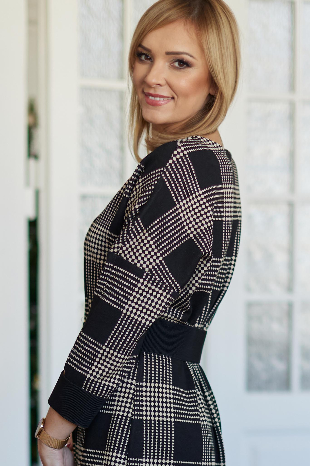 Beige and black checkered dress below the knee with a belt included